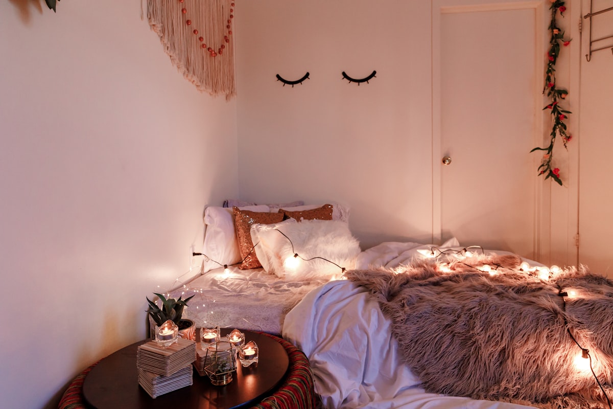 a cozy boho room decor with candles and string lights related to Cozy Nights Ahead: Elevating Home Decor with Quilts & Coverlets Bedding