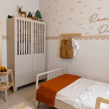 A cozy child's bedroom with a single bed. related to Creating a Royal Nursery with Purple Crib Bedding