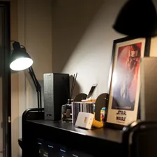 a desk with a lamp and a picture on it related to Breathe New Life into IKEA Bjursta