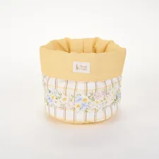 A fabric storage basket with a yellow rim and floral plaid pattern related to Transform Your Bedroom with a Yellow Bed in a Bag