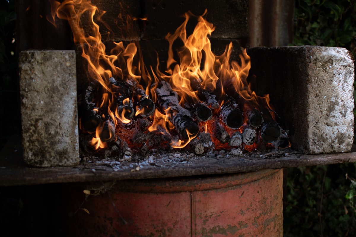 a fire burning in a fireplace related to Chiminea or Fire Pit: Which One is Better for Heat?