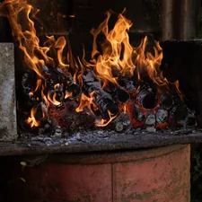a fire burning in a fireplace related to Chiminea or Fire Pit: Which One is Better for Heat?
