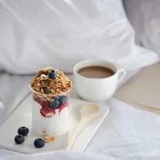 a glass of yogurt and a cup of coffee on a tray related to Fueling Sleep: The Power of Oatmeal Before Bed