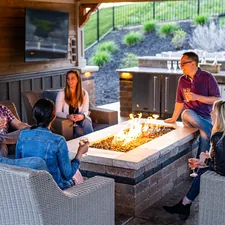 a group of people sitting around a table with a fire in it related to Warm Up Your Patio: A Comprehensive Guide to Cast Iron Chiminea Reviews