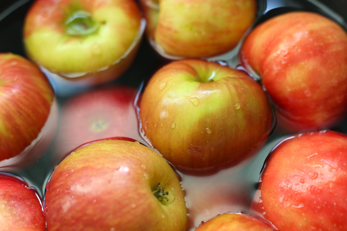 a group of red and yellow apples floating in water related to Apple Valances in the Kitchen: A Juicy Twist for All