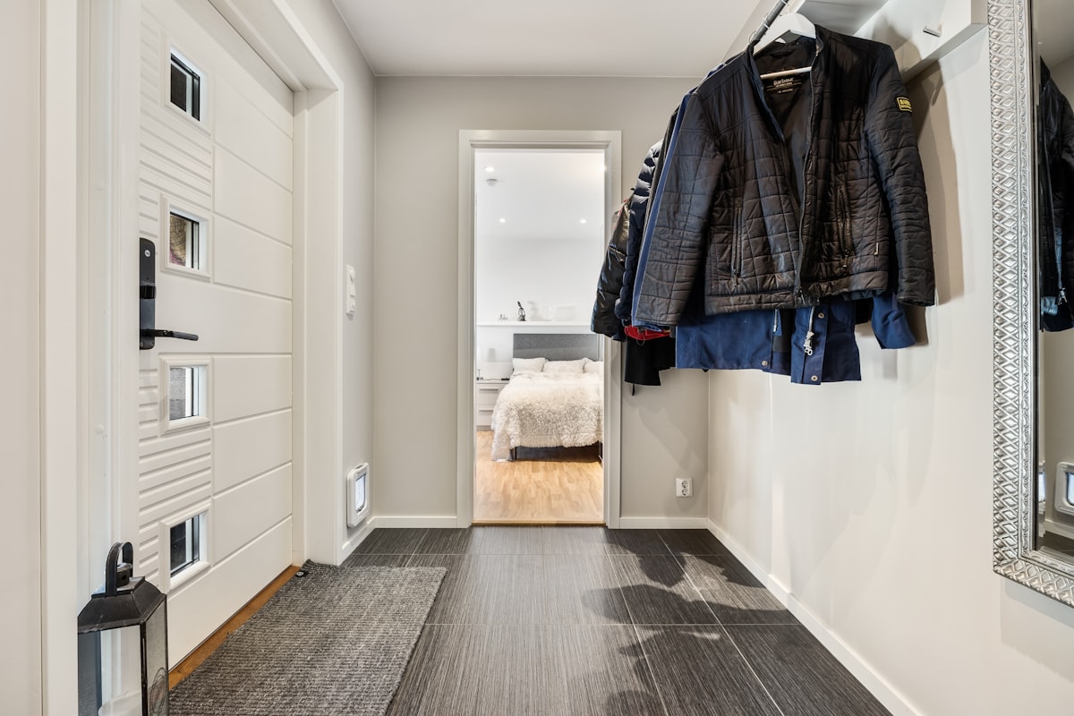 A hallway with a coat rack and mirror related to Revamping Your Entryway with a Smart Entryway Coat Closet