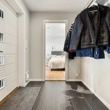 A hallway with a coat rack and mirror related to Revamping Your Entryway with a Smart Entryway Coat Closet