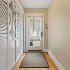 a hallway with a door and a rug on the floor related to Maximizing Space and Style with Entryway Storage Furniture