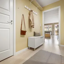 A hallway with a white door and yellow walls related to Elevate Your Entryway with Elegance: White Entryway Bench Ideas