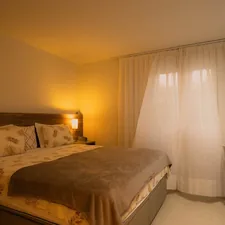 A hotel room with a bed and television related to Best Bed Chair Pillows for Comfort and Support