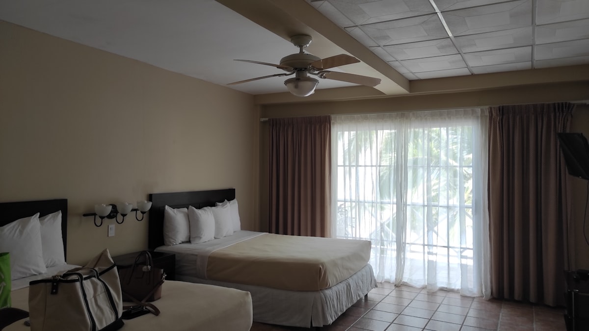 a hotel room with two beds and a ceiling fan related to The Ultimate Comfort: Double Room with Two Double Beds