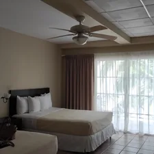 a hotel room with two beds and a ceiling fan related to The Ultimate Comfort: Double Room with Two Double Beds