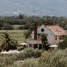 a house surrounded by trees related to Escape to Paradise: Napa Valley Bed and Breakfast