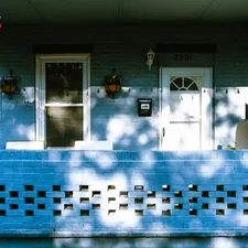A house with a blue front porch and a white door related to Exploring the Charm of Bed and Breakfasts in Pennsylvania