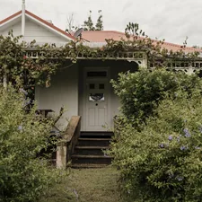 a house with a white door surrounded by bushes related to Unwind in Walla Walla: Bed and Breakfast Bliss Awaits