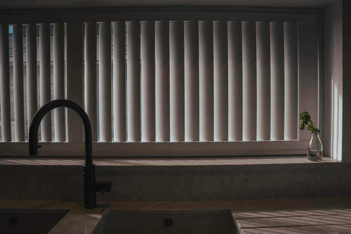 a kitchen sink with a faucet next to a window related to Window Valances for Kitchen: Elevate Your Window Style