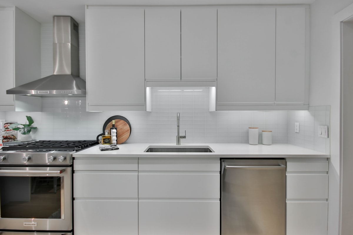 a kitchen with white cabinets and stainless steel appliances related to White Kitchen Valances: A Comprehensive Guide