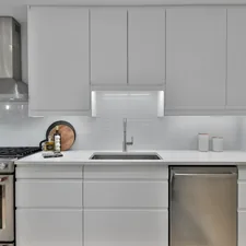 a kitchen with white cabinets and stainless steel appliances related to White Kitchen Valances: A Comprehensive Guide