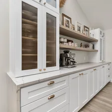 a kitchen with white cabinets and wood floors related to Elevate Your Kitchen: Discover the Perfect Kitchen Sideboard Cabinet