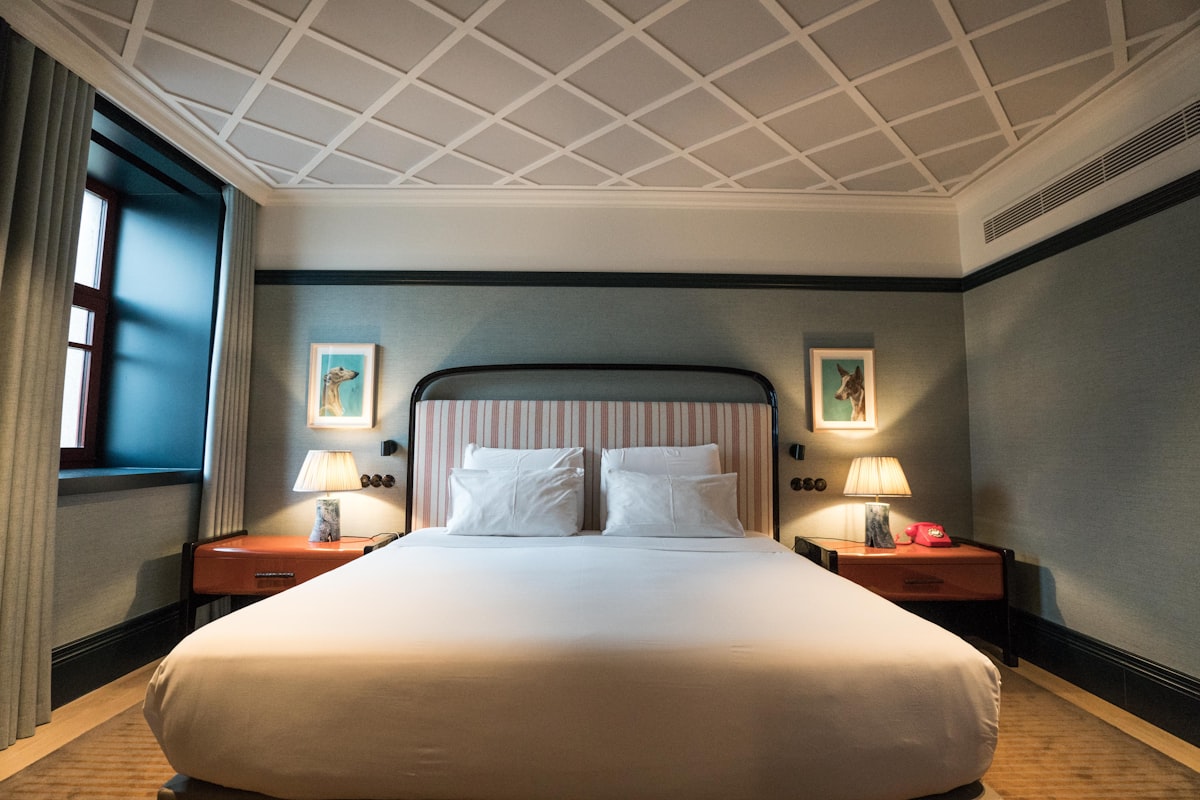 A large bed sitting in a bedroom next to a window related to The Ultimate Guide to Hotel Rollaway Beds: Comfort and Convenience