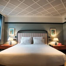 A large bed sitting in a bedroom next to a window related to The Ultimate Guide to Hotel Rollaway Beds: Comfort and Convenience