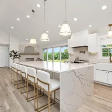 a large kitchen with a marble island and white cabinets related to Elevate Your Kitchen Style: Modern Valances for Windows