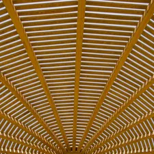 a large open area with a wooden ceiling related to Elevate Your Home's Curb Appeal with These Stunning Entryway Roof Designs