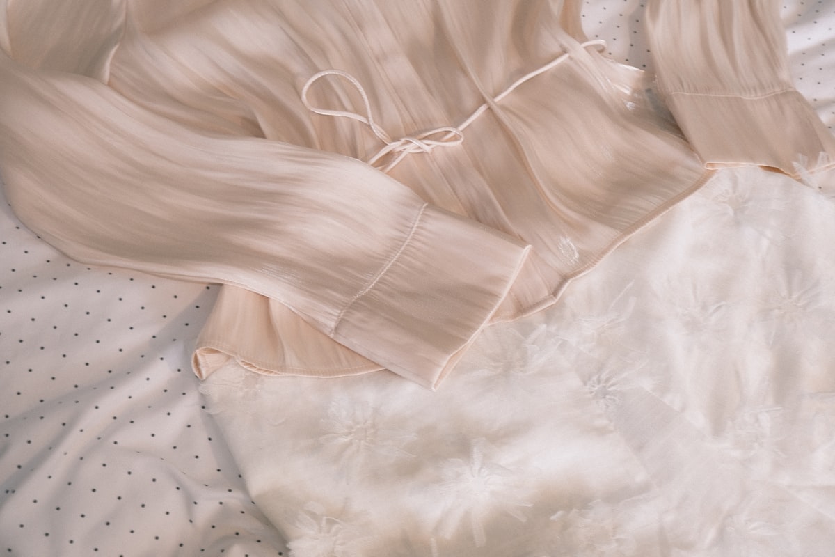 A light pink blouse with a tie waist related to The Ultimate Guide to Silk Bedding Sets