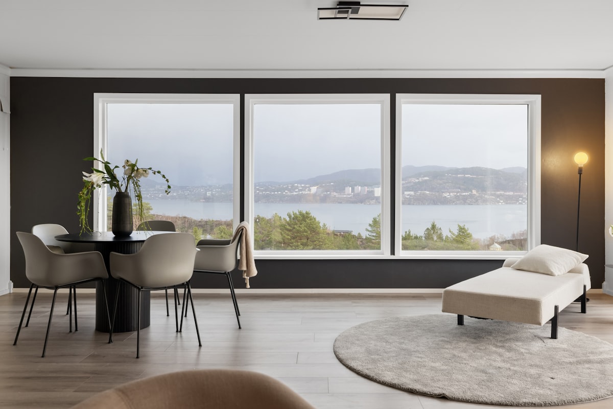 A living room filled with furniture and a large window related to Elevate Your Windows with Unique Valances