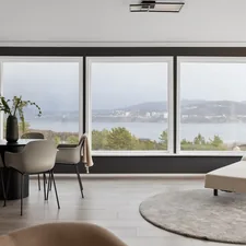 A living room filled with furniture and a large window related to Elevate Your Windows with Unique Valances