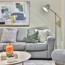 a living room filled with furniture and a painting on the wall related to Elevate Your Living Room Style with These Valances for Windows