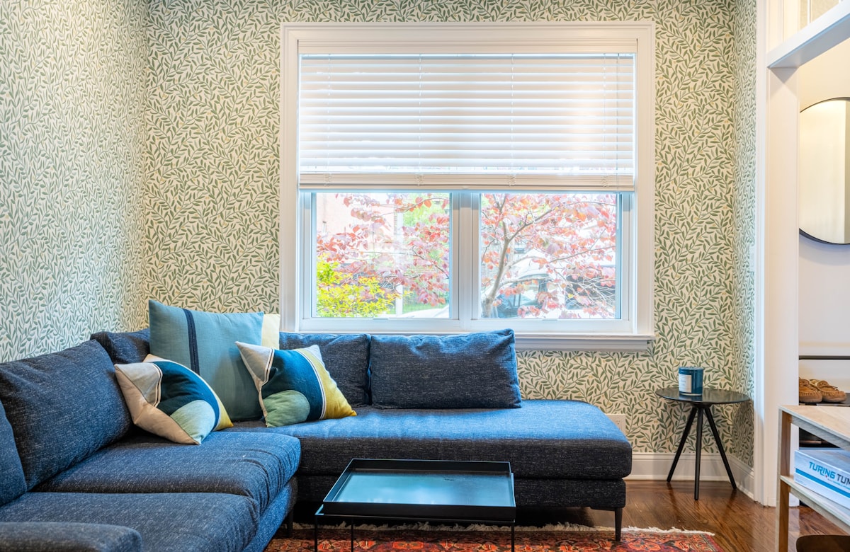a living room with a blue couch and a coffee table related to Ultimate Guide to Sofa Bed Sectionals: Comfort and Convenience Combined