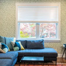 a living room with a blue couch and a coffee table related to Ultimate Guide to Sofa Bed Sectionals: Comfort and Convenience Combined