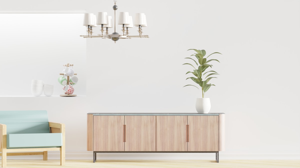 a living room with a couch, a chair and a potted plant related to Elevate Your Dining Space with Modern Sideboards and Buffets