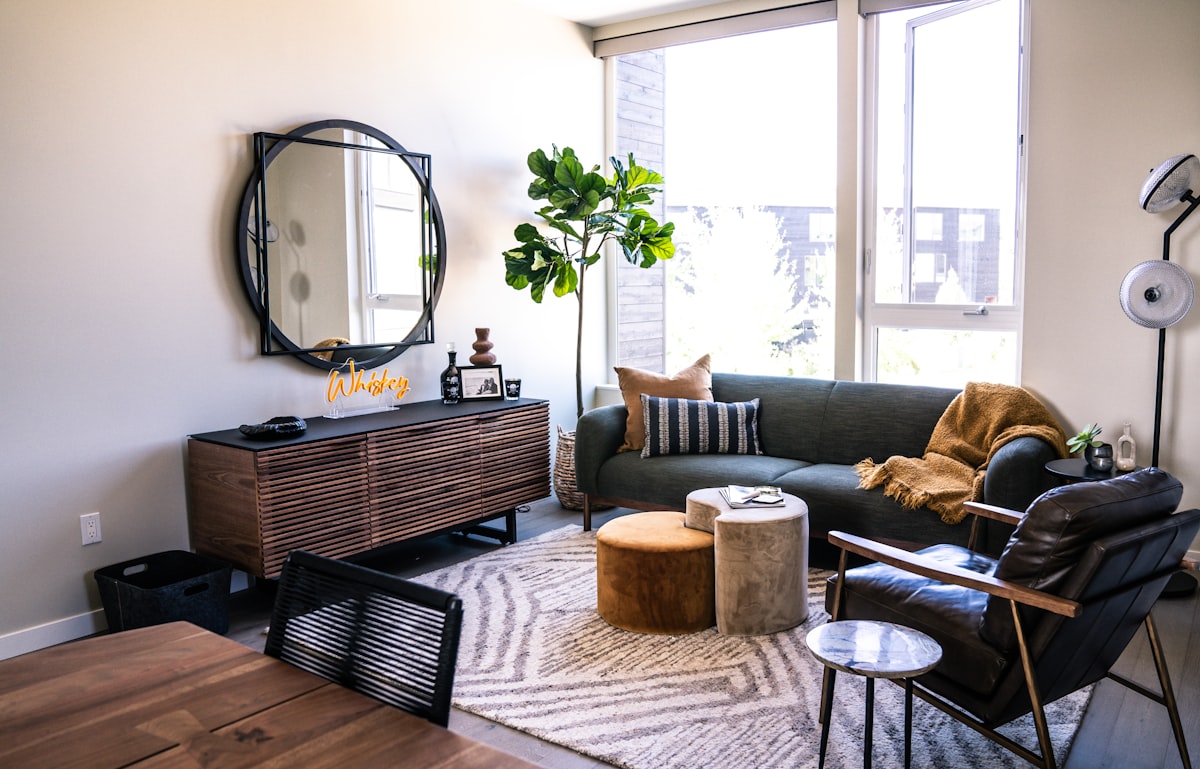 a living room with a couch and a table related to Elevate Your Living Room Style with Tailored Valances