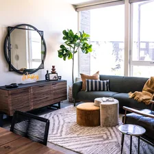 a living room with a couch and a table related to Elevate Your Living Room Style with Tailored Valances