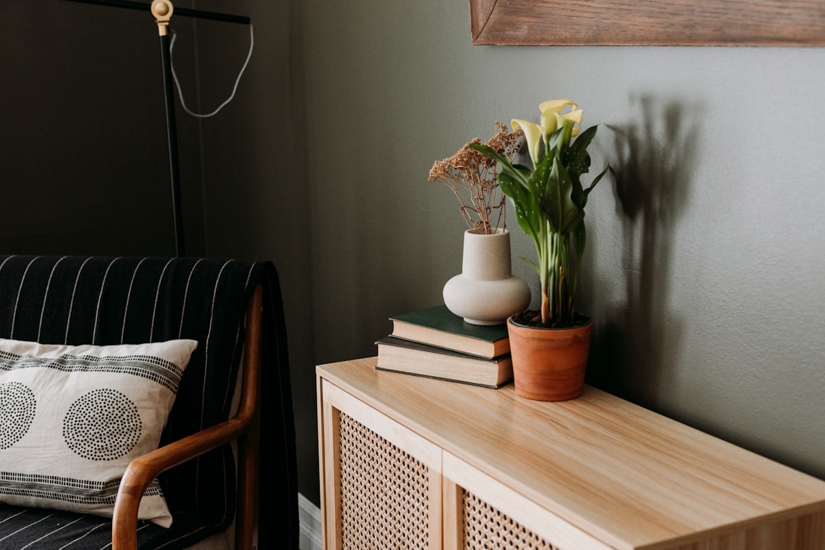 a living room with a couch and a table with a vase of flowers on it related to Timeless Elegance: The Ultimate Guide to Crate and Barrel Sideboard