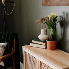 a living room with a couch and a table with a vase of flowers on it related to Timeless Elegance: The Ultimate Guide to Crate and Barrel Sideboard