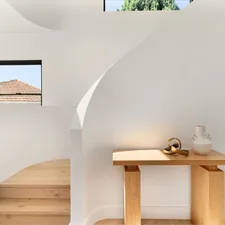 A living room with a table and stairs related to Stunning Unique Entryway Tables to Elevate Your Home's Style