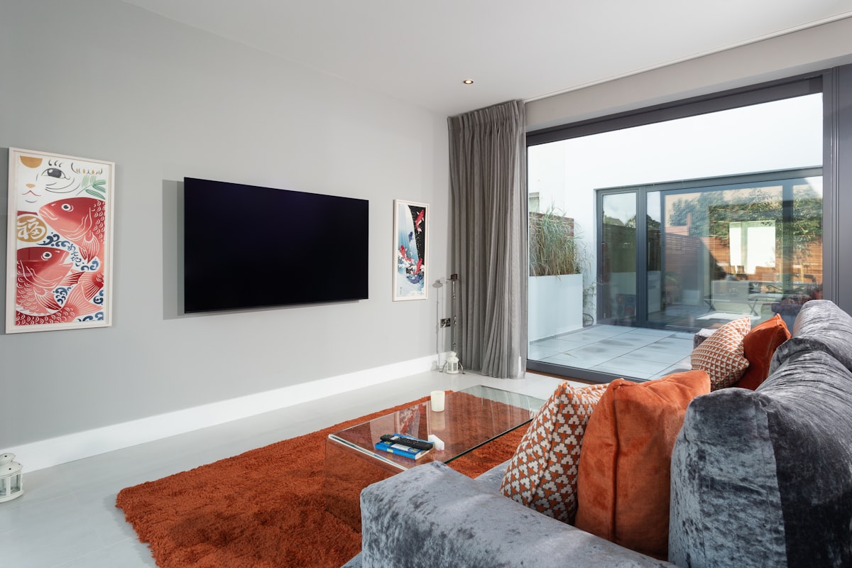 a living room with a tv and couches related to Maximizing Comfort and Functionality: The Ultimate Sofa Bed Guide