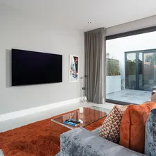 a living room with a tv and couches related to Maximizing Comfort and Functionality: The Ultimate Sofa Bed Guide