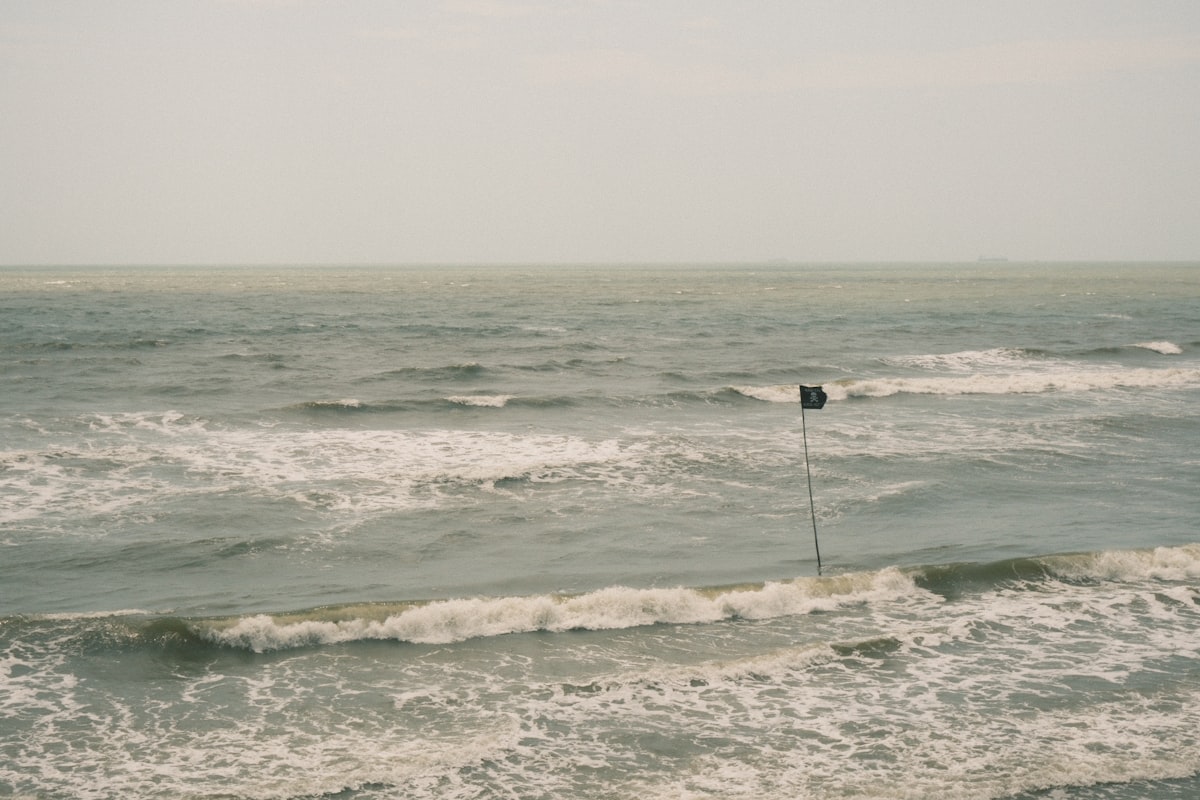 A lone black flag stands in the choppy ocean waves. related to Explore the Best Home Essentials in Flagstaff