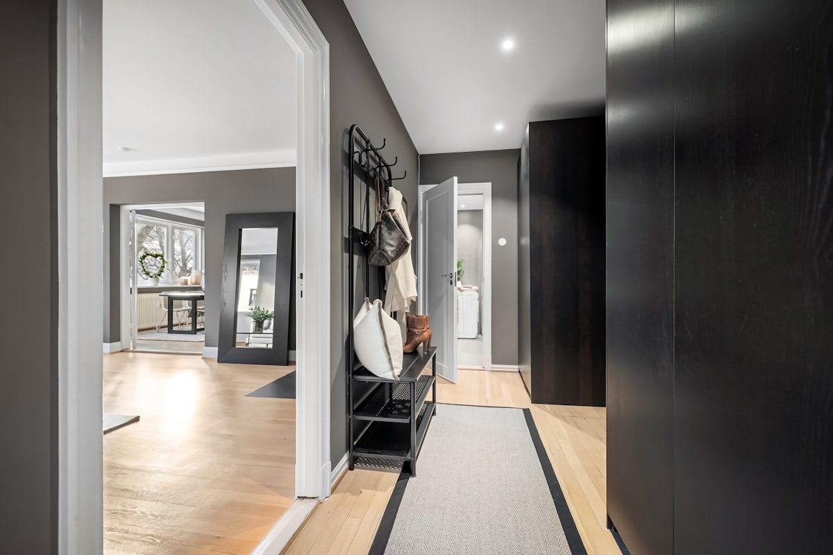 A long hallway with a clock on the wall related to Maximizing Space and Style: Entryway Hall Trees with Storage