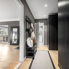 A long hallway with a clock on the wall related to Maximizing Space and Style: Entryway Hall Trees with Storage