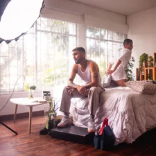 a man and a woman sitting on a bed related to The Ultimate Guide to Bed Dividers for Couples