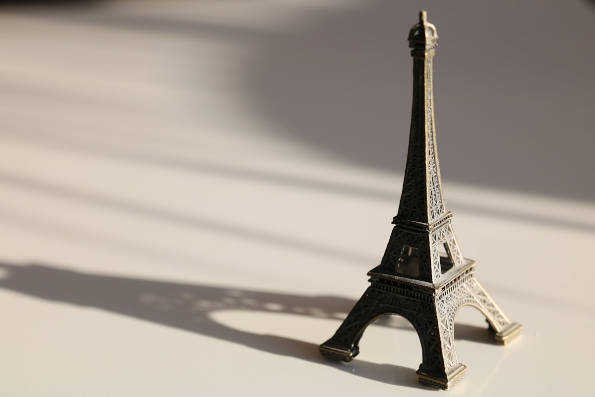 a miniature model of the eiffel tower on a table related to Sleeping Beauty: Dreams Above the City