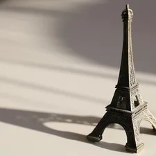a miniature model of the eiffel tower on a table related to Sleeping Beauty: Dreams Above the City