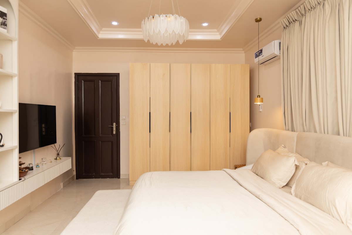 A modern bedroom with a bed, wardrobes, and television. related to Maximize Space with Stylish Loft Beds Featuring Storage Options