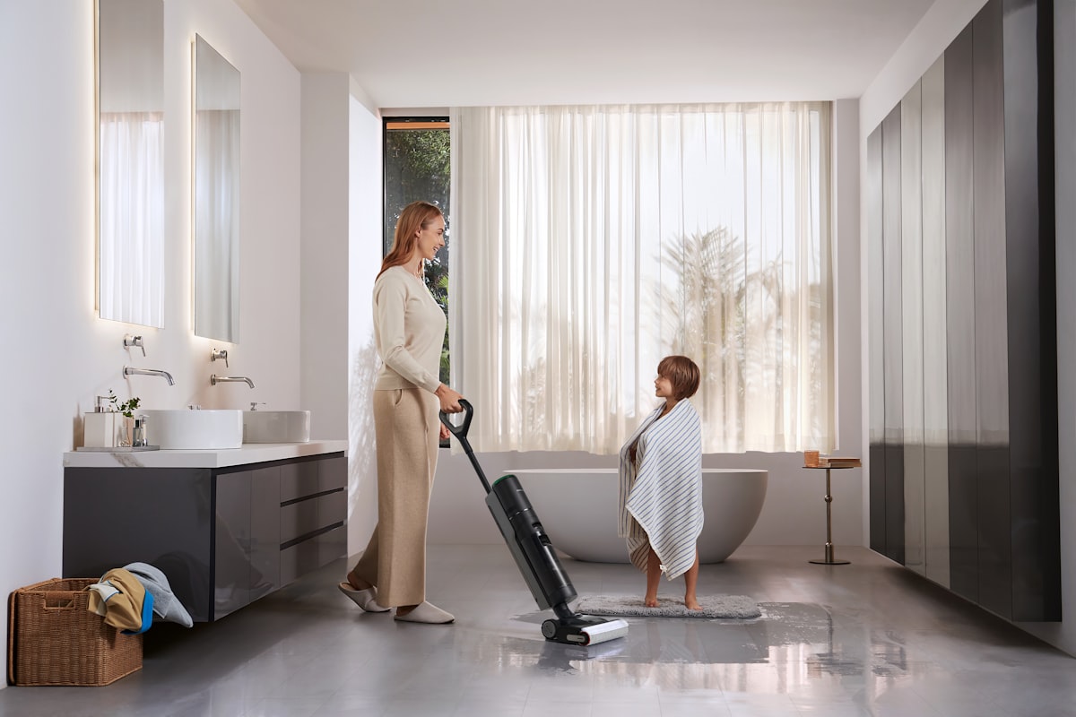 A mother uses a Dreame wet dry vacuum to clean bathroom tiles after her son’s bath, showcasing fast cleanup for everyday messes. related to Elevate Your Home with Black and White Curtain Valance