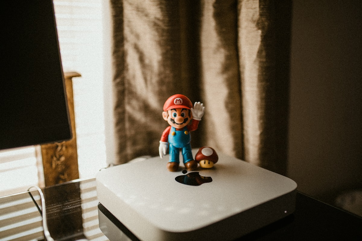 a nintendo figurine sitting on top of a white box related to Transform Your Bedroom with a Nintendo Bed Set: A Gamer's Dream